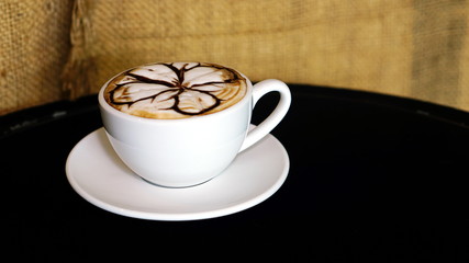 Cappuccino coffee with milk put on a table.