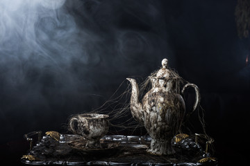 An ancient teapot in a cobweb
