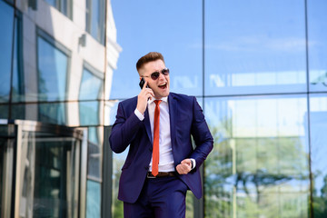 Businessman talking on the phone and smiling.