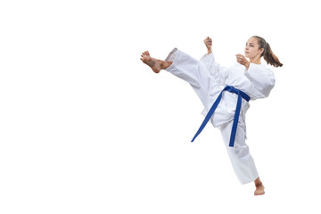 On a white background the sportswoman beats a kick leg