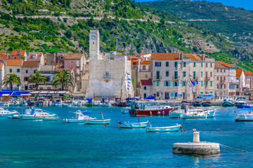 Naklejka premium Komiza town seafront. / Seafront view at coastal town Komiza in south of Croatia, Island Vis.
