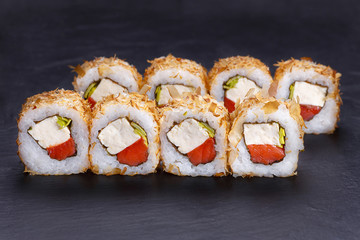 Tasty uramaki sushi roll with tuna and cream cheese decorated with dried fish flakes