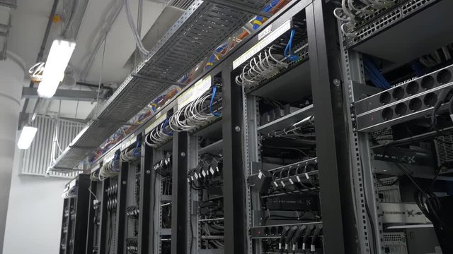 Row of bitcoin miners set up on the wired shelfs. Computer for Bitcoin mining. cables plug to motherboard for mining machine. Cryptocurrency computer with many peripheral slots