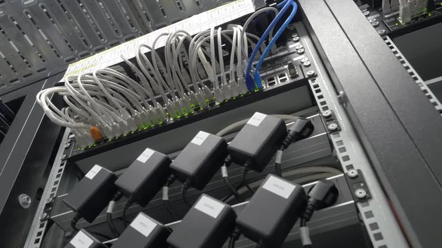 Storage servers are located in the server room of the data center. Back of the server installed in the server room. Many cables are connected to a powerful computers