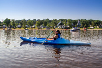 woman kayaking on a calm lake