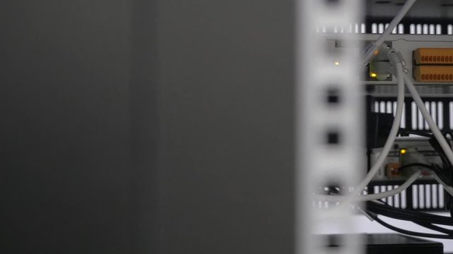 Back of the server installed in the server room. Many cables are connected to a powerful computers. Front panel of the central router. Optical links of a powerful Internet server. Connection of