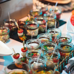 Decorated catering banquet table with different food appetizers assortment on a party

