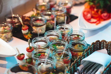 Decorated catering banquet table with different food appetizers assortment on a party
