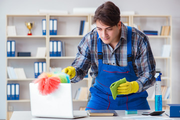 Male cleaner working in the office