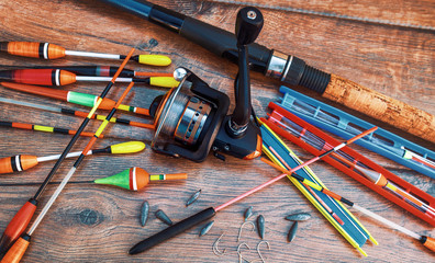 Fishing tackle on a old wooden table. Sport and recreation concept