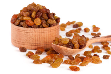 raisins in a wooden bowl with spoon isolated on white background