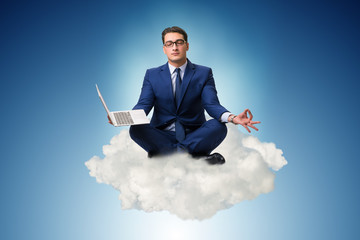 Businessman working on laptop in the sky