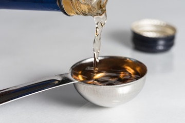 Pouring Cooking Sherry into a Teaspoon