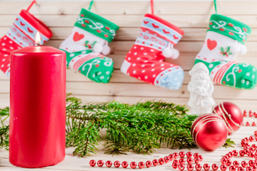 Christmas wooden background with colorful socks, candle and decor. new year and advent.