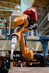 Closeup robot welding arm in car factory