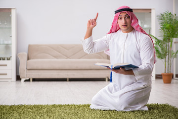 Fototapeta premium Arab man praying at home