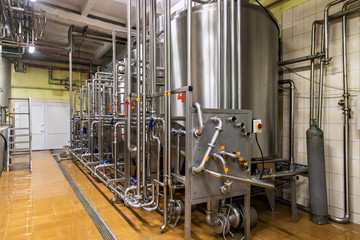Industrial dairy production. Storage steel tanks on the milk factory.