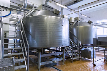 Industrial dairy production. Storage steel tanks on the milk factory.