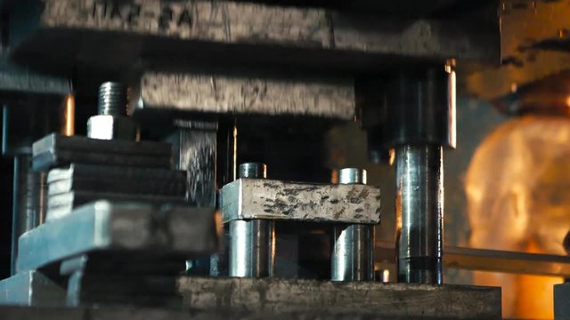 The machine cuts the sheet metal. Large hydraulic guillotine shears.