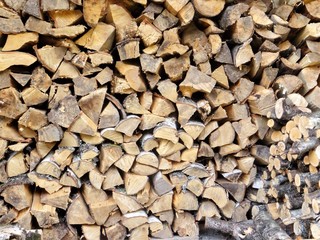 Dry , split firewood stacked.