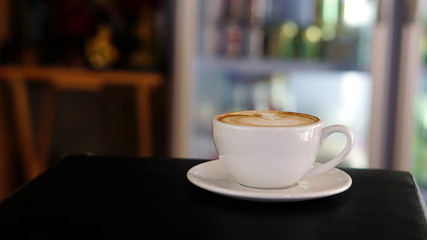 Latte art and cappuccino on the table with roasting coffee beans. Beverage and breakfast or food and drink menu with hot coffee at the cafe shop.
