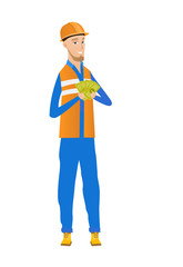 Young caucasian builder holding money.