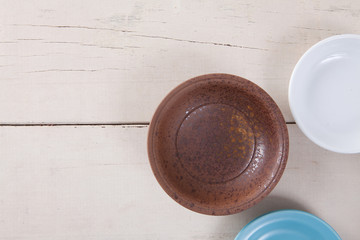 Top view of empty colorful plate put on white wood table with space for copy.