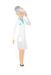 Senior caucasian doctor talking on a mobile phone.