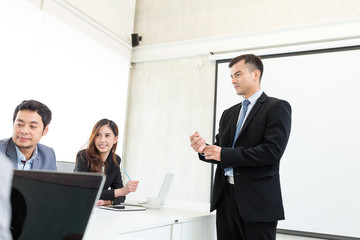Group of business people discuss in office