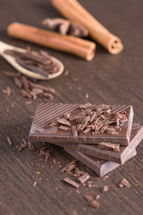 Dark chocolate on wood background.