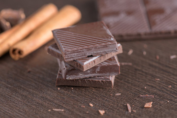 Dark chocolate on wood background.
