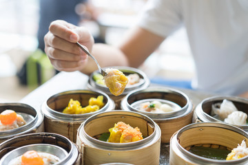 Man's hand hold dim sum. Selective focus.