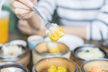 Women's hand hold dim sum. Selective focus.