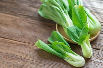 Bok choy (chinese cabbage) on wooden table.