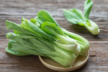 Bok choy (chinese cabbage) on wooden table.