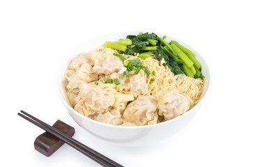 Wonton and egg noodle soup of Chinese Cantonese style for asian cuisine serving with Chinese cabbage (bog choy) and topped with chopped green onion over bamboo plate mat isolated on white background
