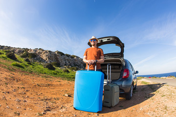 happy man enjoying road trip and summer vacation. Travel, holidays and people concept