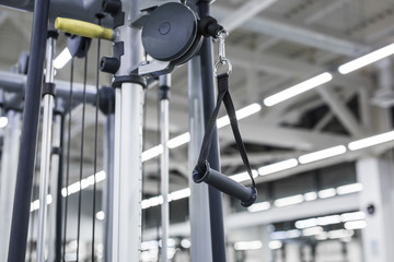 Closeup picture of hanging handle machine in a gym for pulling training