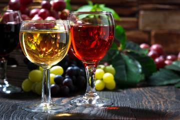 glasses of wine on dark wooden background, closeup