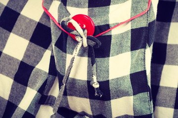 Closeup, checked black and white pattern with button