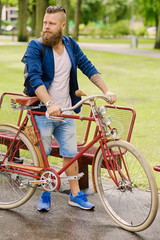 Obraz premium A man on a retro bicycle in a park.