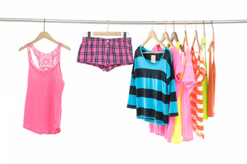 colorful shirts, pants on wooden hangers