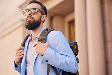 Urban traveller bearded man with a backpack.