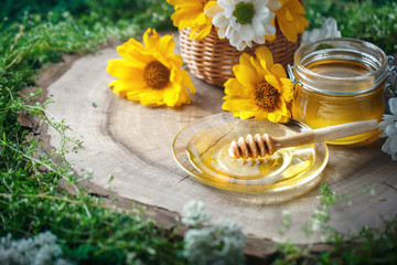 Fototapeta na wymiar Fresh flower honey on a wooden table. Selective focus.