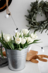 A bouquet of tulips in an iron bowl on a table