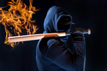 A violent man has a beating stick in his hand