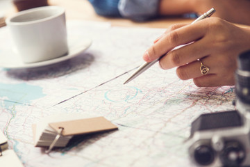Travel planning - map with note  pen and camera