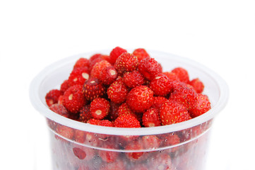 A glass of wild strawberry on a white background