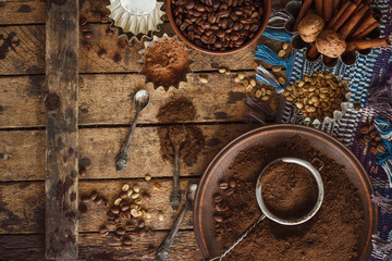 Roasted black and green coffee beans and ground coffee in the plate