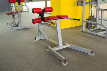 Fototapeta na wymiar Sport, training and healthy lifestyle concept - gym interior with equipment
